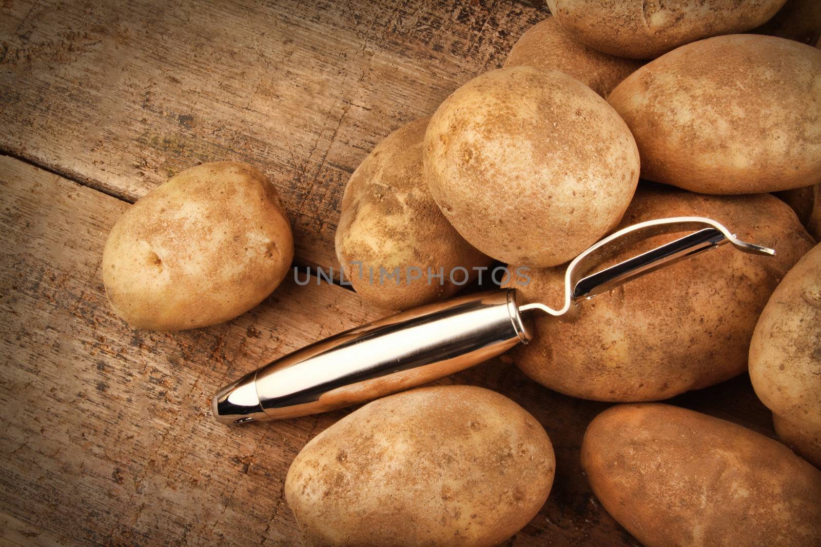 Harvest potatoes on wooden background 