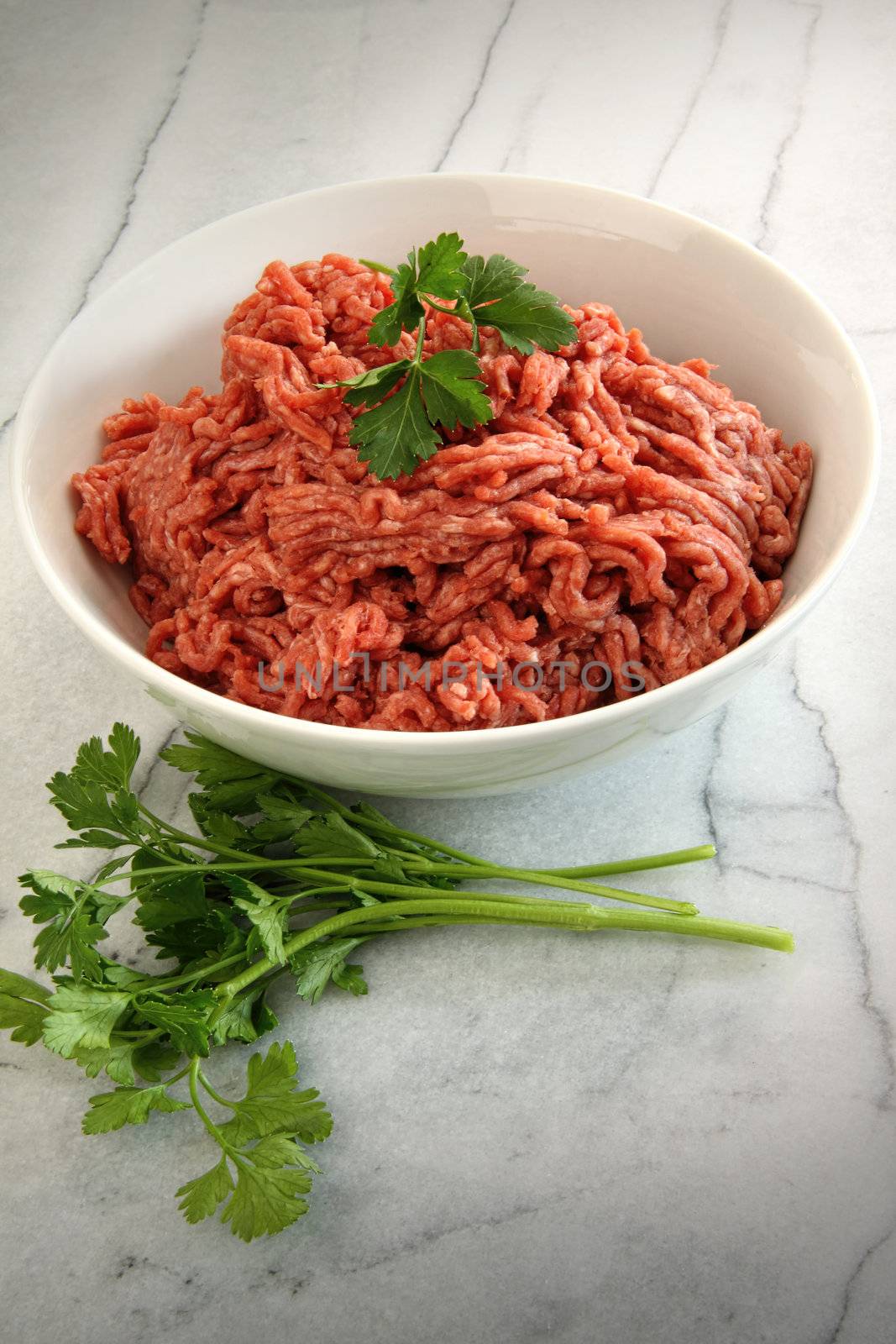 Close up of raw ground beef on marble cutting board 