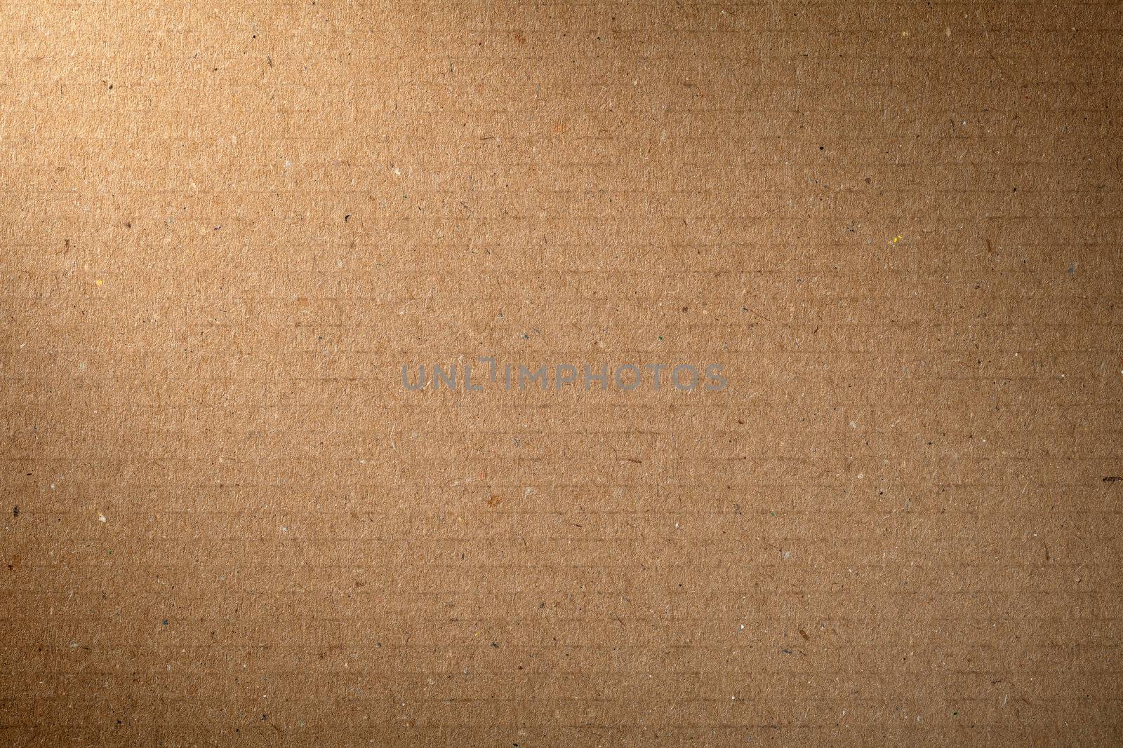 Brown cardboard texture for background, lighting from the left corner