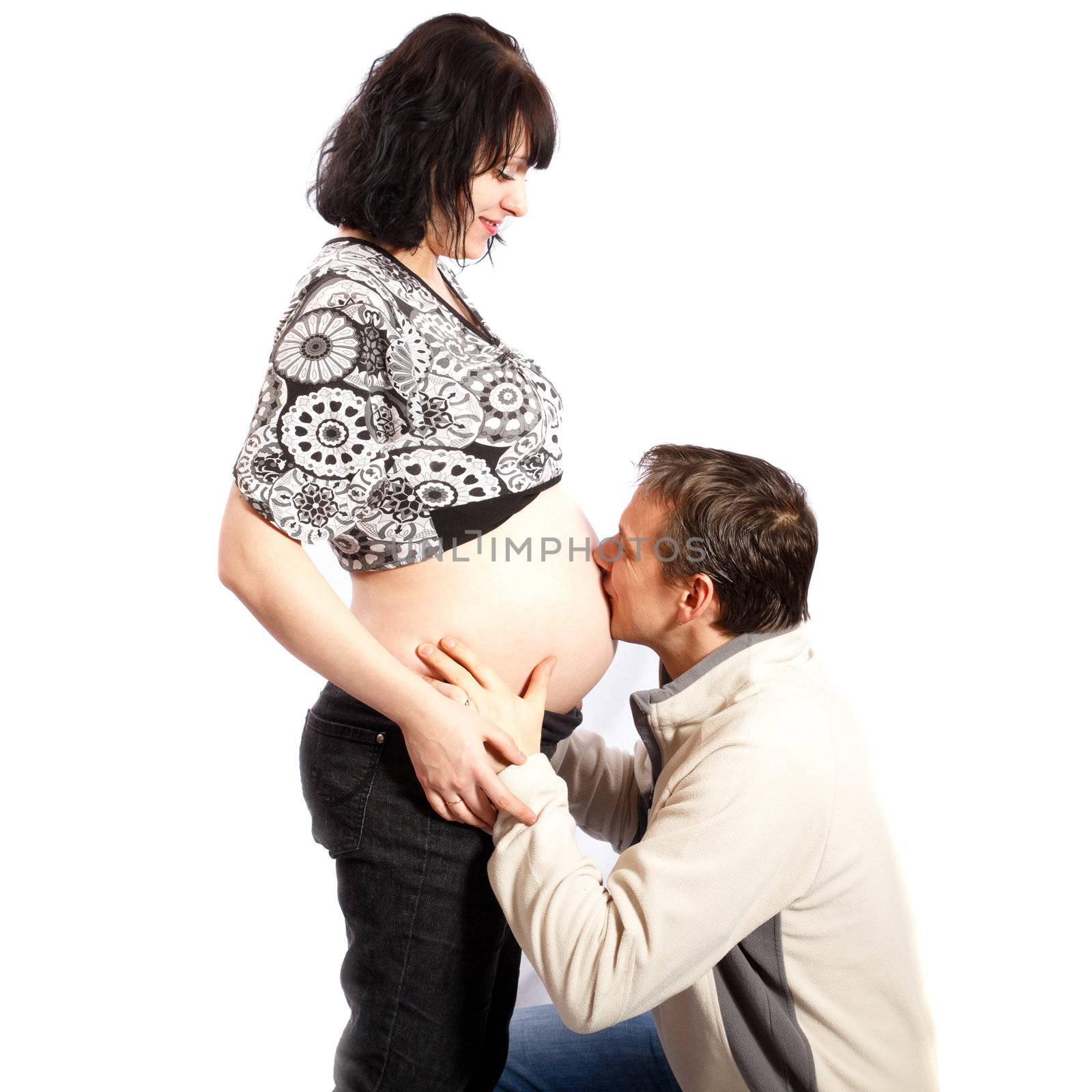 happy family, man kissing woman's pregnant belly  a white background
