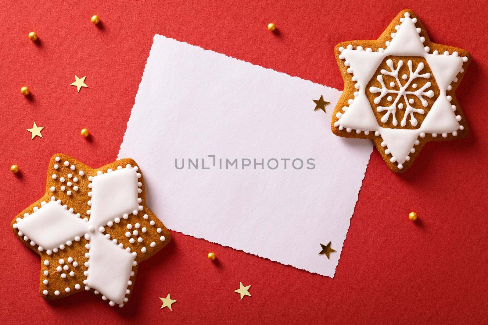 Christmas greeting card with gingerbreads, gold stars and balls. Top view