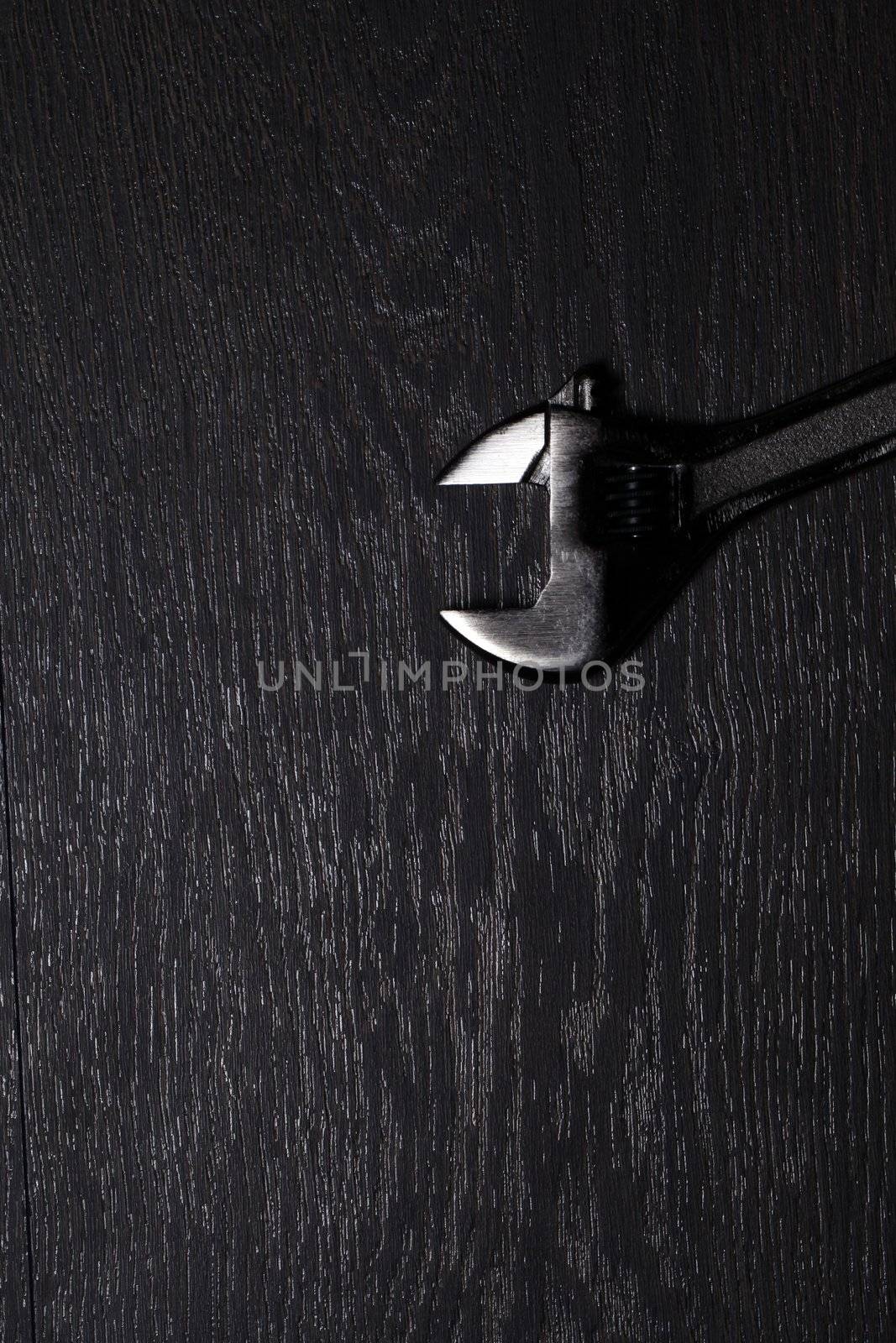 Metal spanner isolated on a wooden table