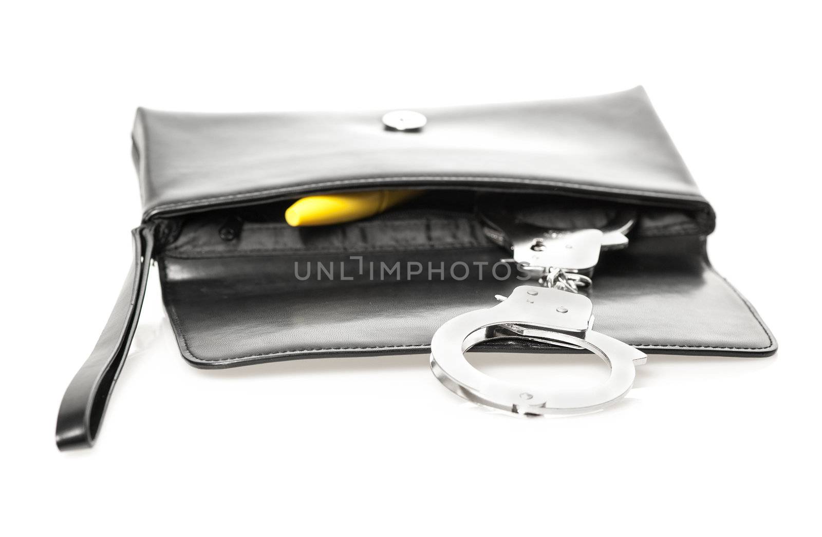 An open black clutch bag/purse with handcuffs and a yellow dildo.