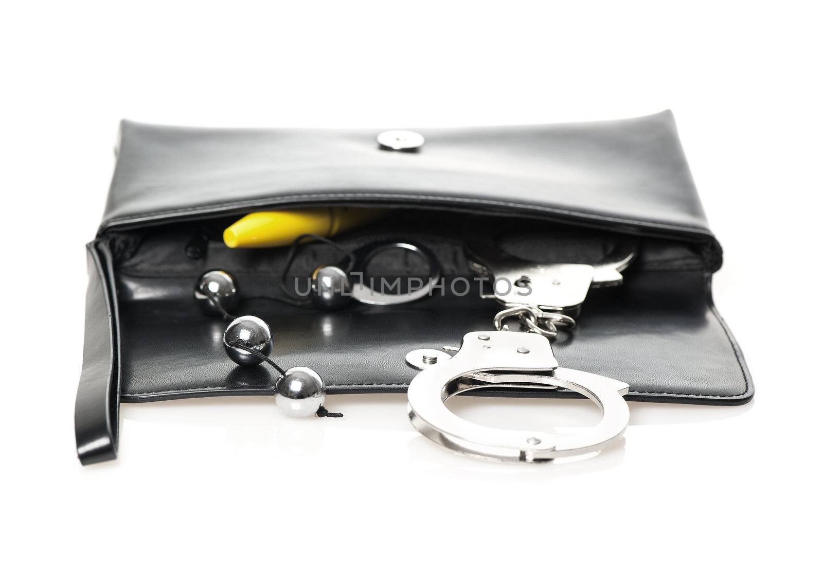 An open black clutch bag/purse with handcuffs, anal beads and a yellow dildo.