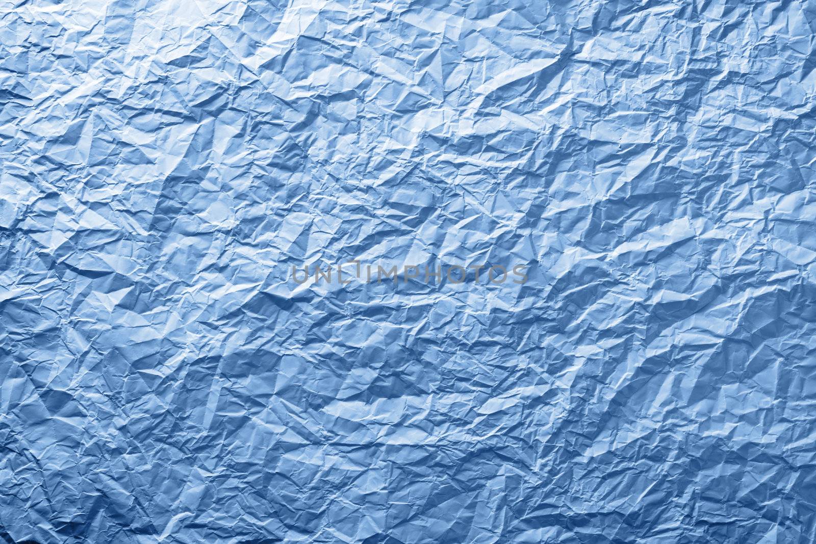Blue crumpled paper texture for background. Top view