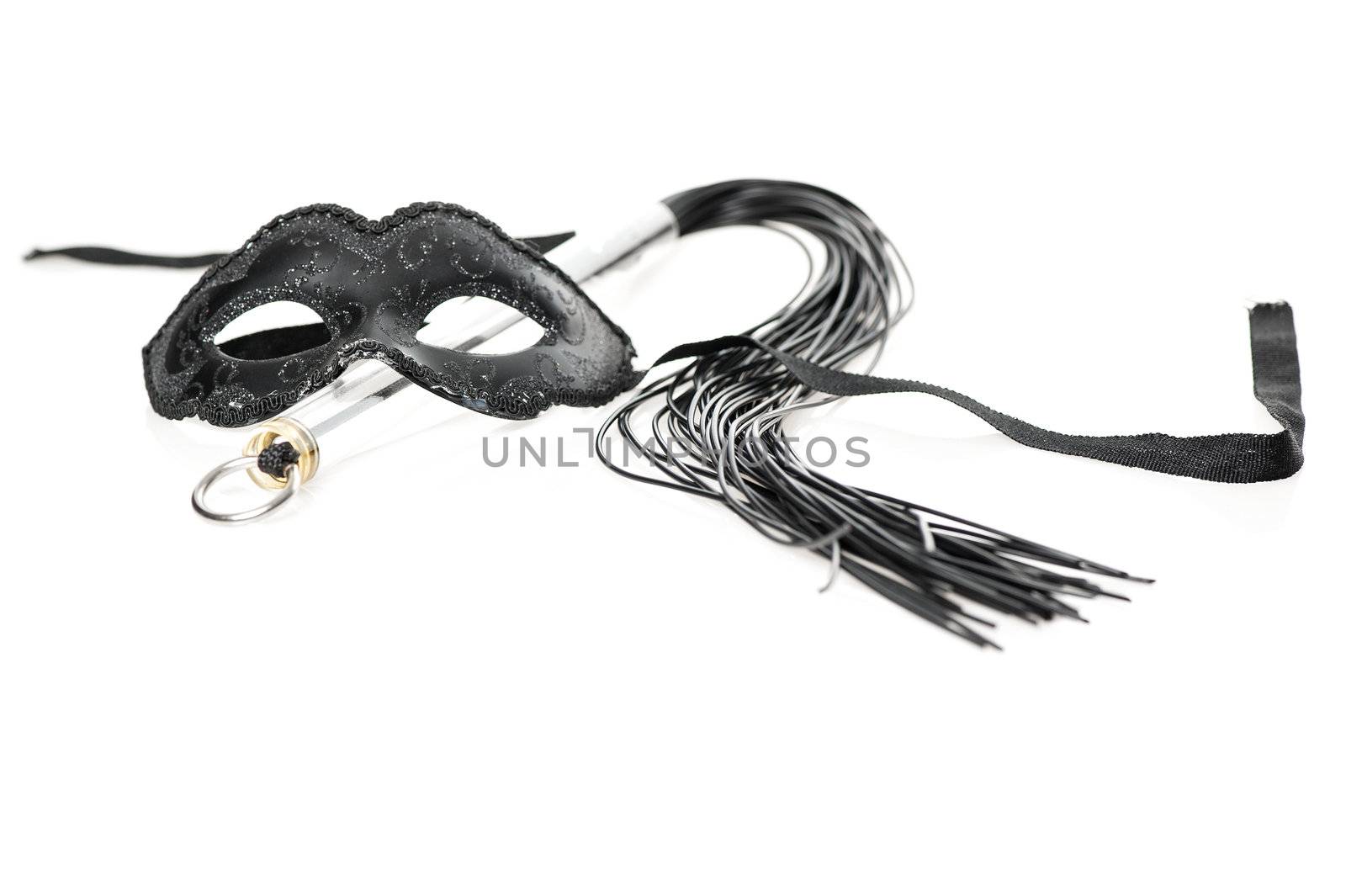 Black mask and fetish whip on white background by stockbymh