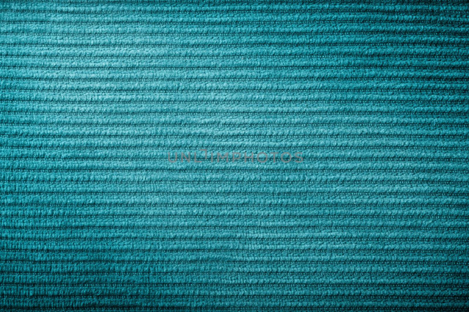 Green corduroy fabric texture for background. Macro shot 