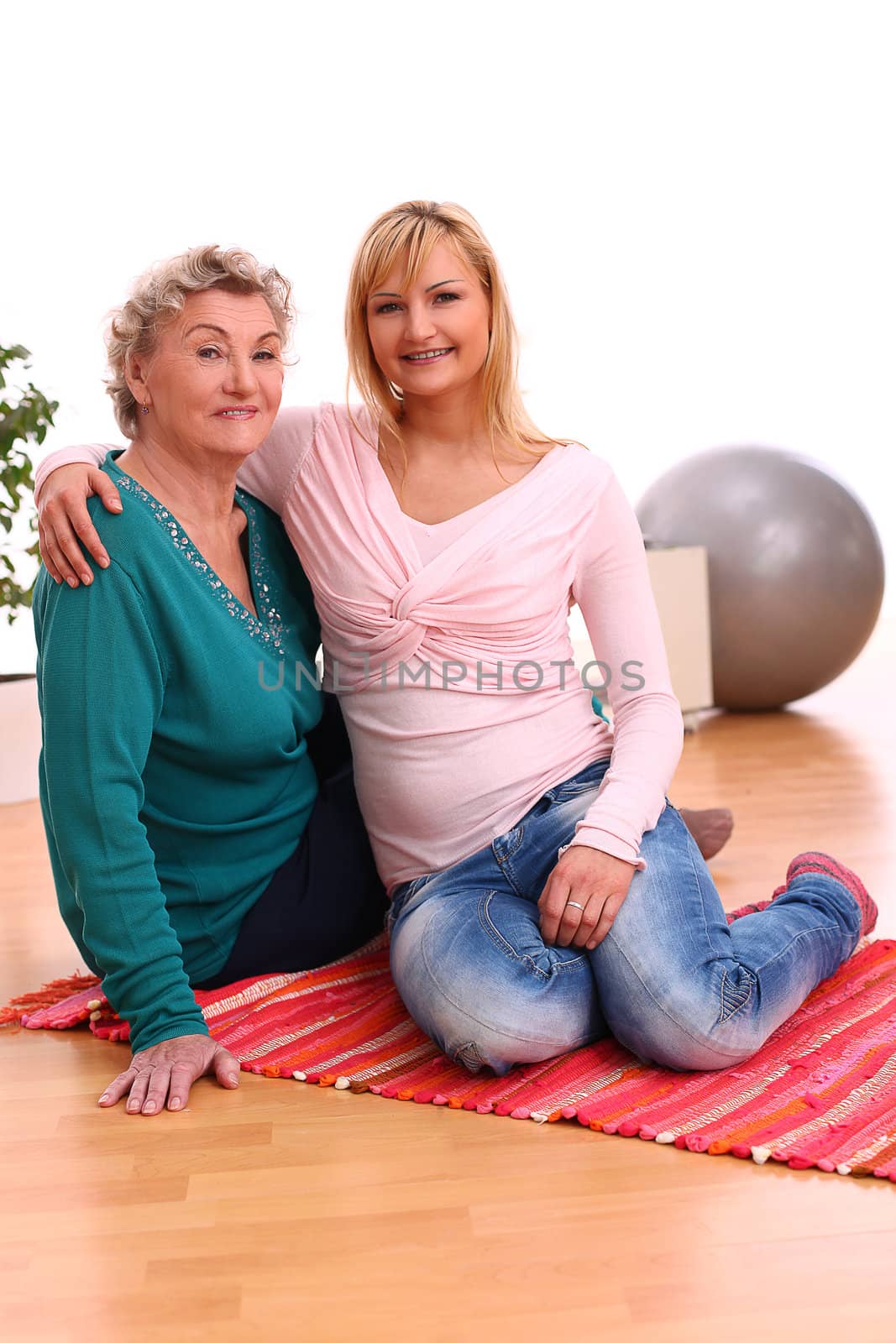 Happy elderly woman with granddaughter at home