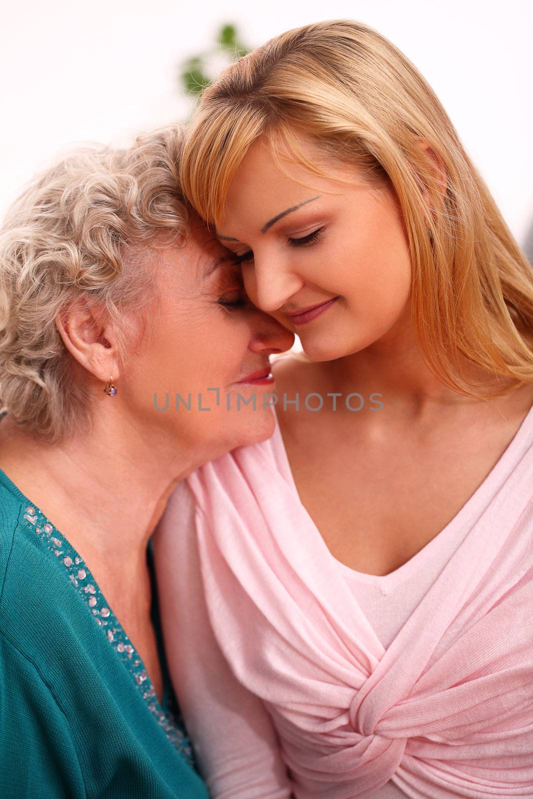 Happy elderly woman with granddaughter at home