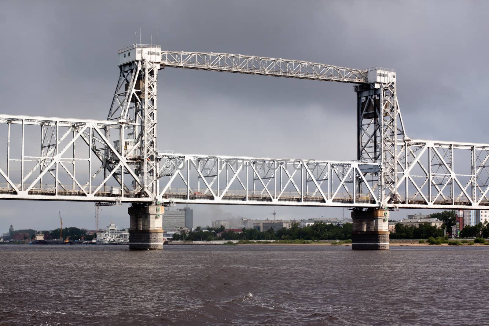 A big metal modern bridge on a river
