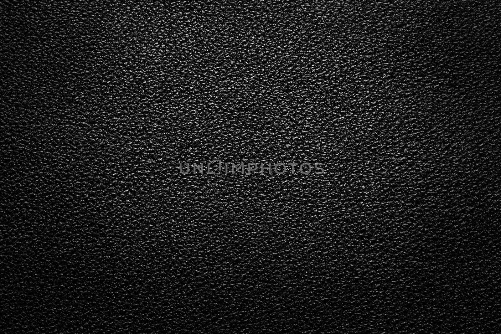 Black leather texture for background with light from above
