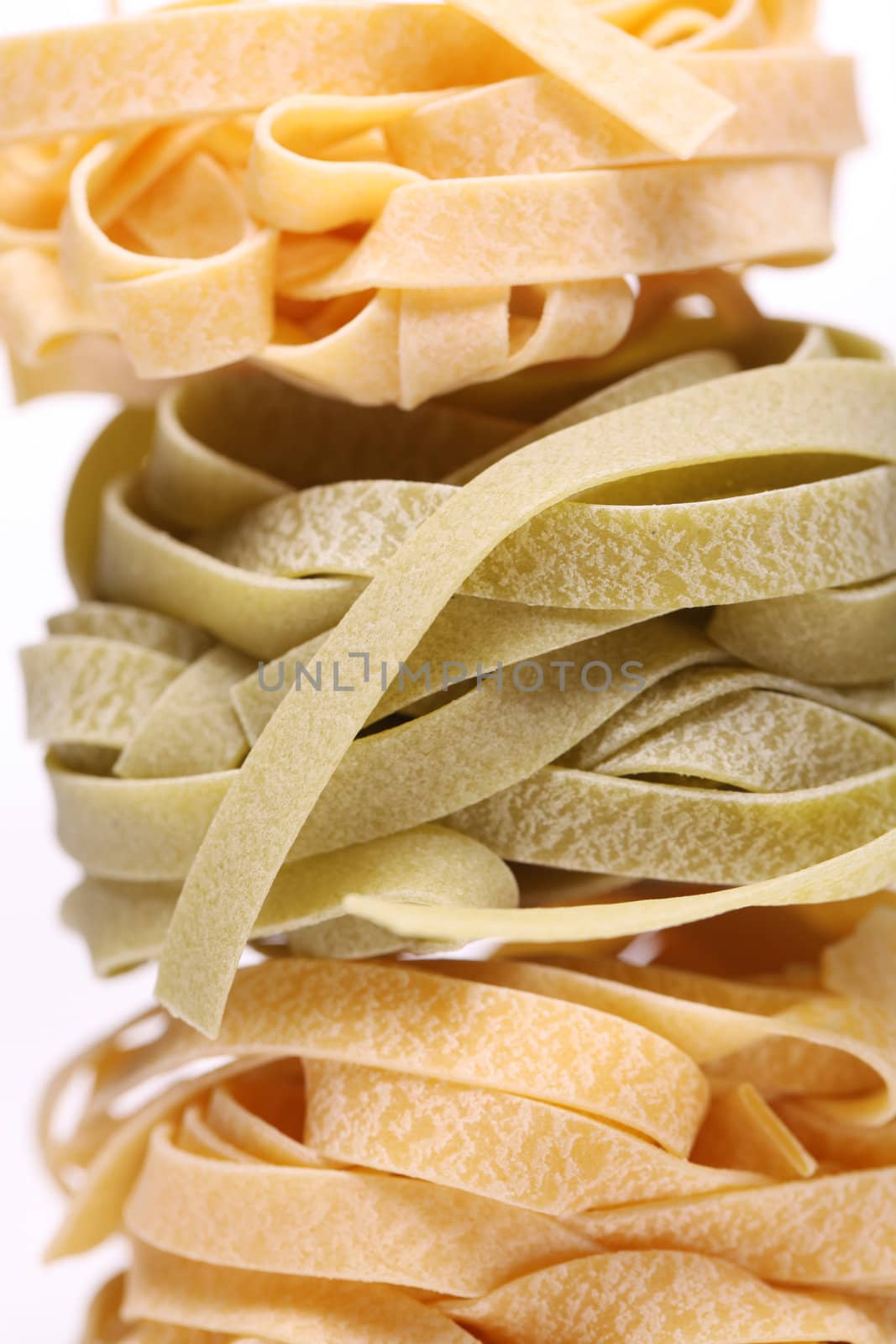 Fresh and tasty tagliatelli isolated over white background