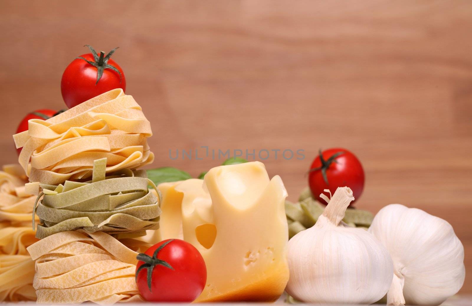 Fresh ingredients for pasta isolated on wooden background