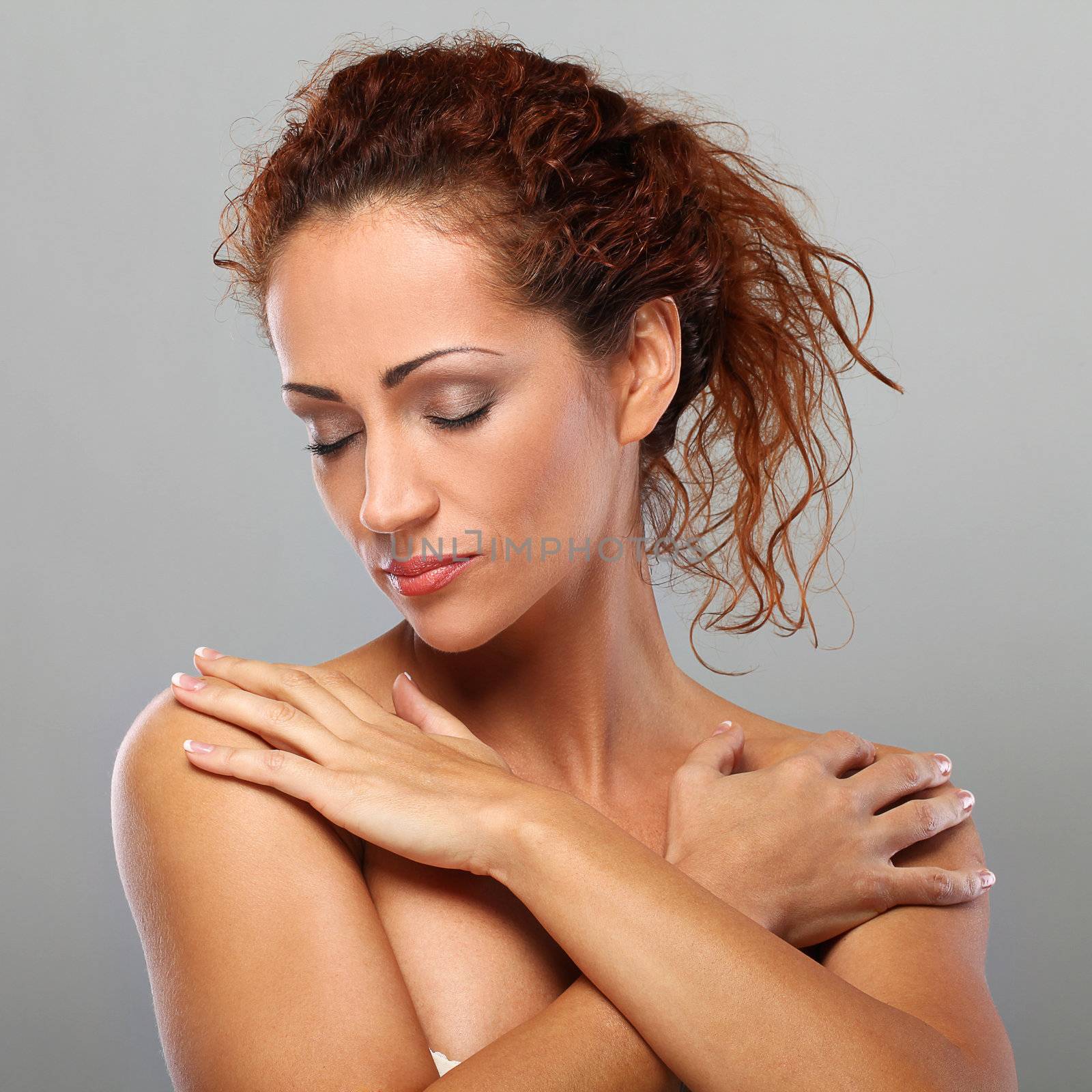 Beautiful natural middle aged woman isolated on grey background