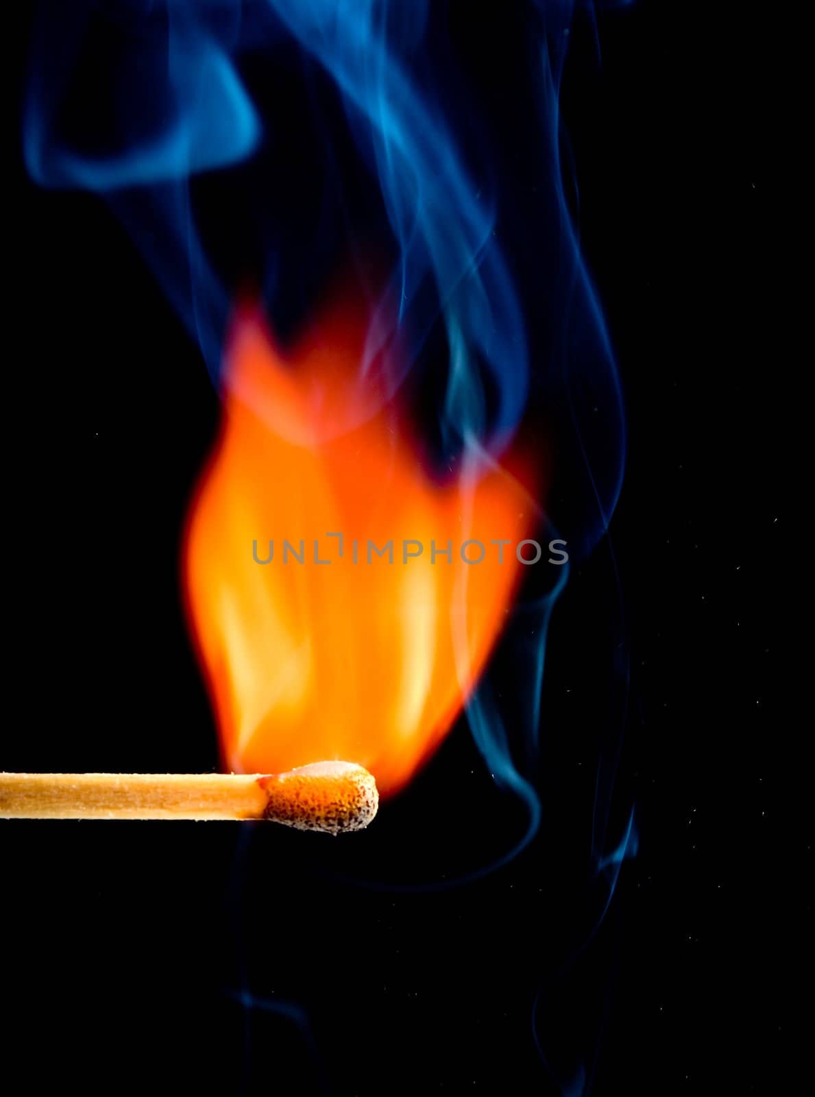 colorful flame with wooden matchstick, isolated on black