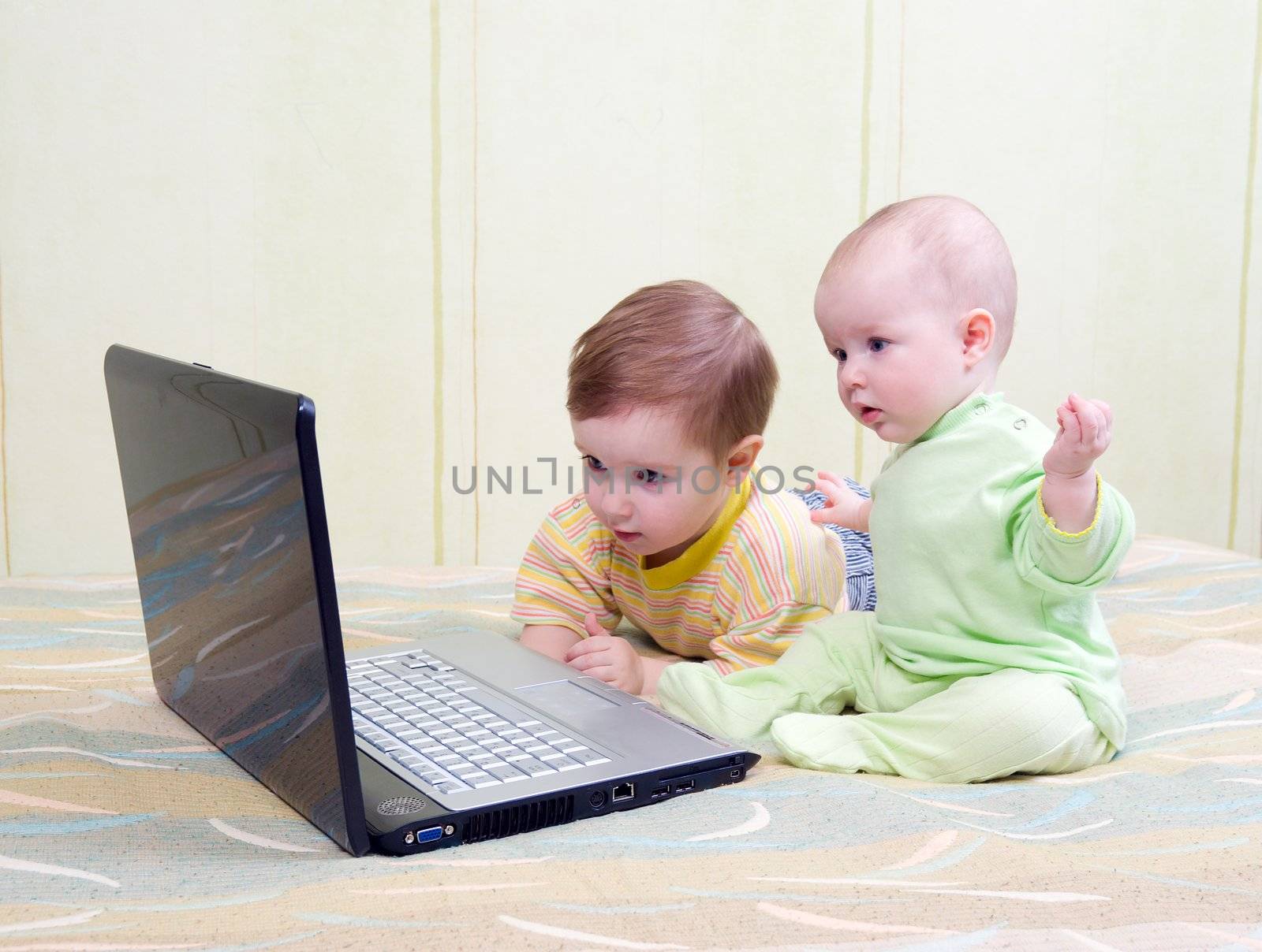 Little girl and boy using laptops.kids playing computer games 