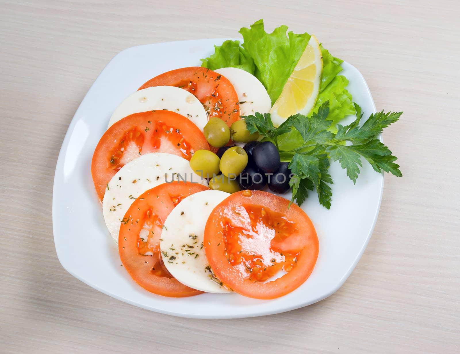 Arrangement of mozzarella and tomatoes.Italian kitchen.