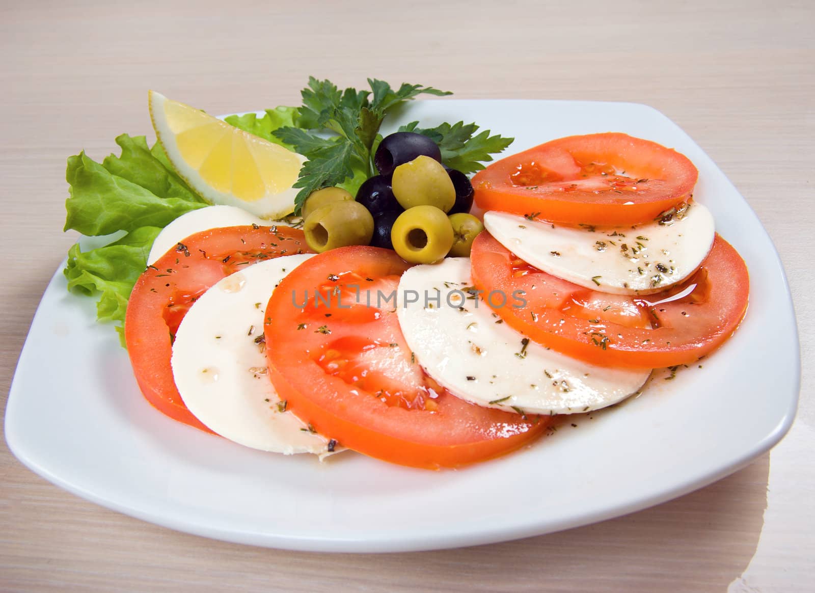 Arrangement of mozzarella and tomatoes.Italian kitchen.