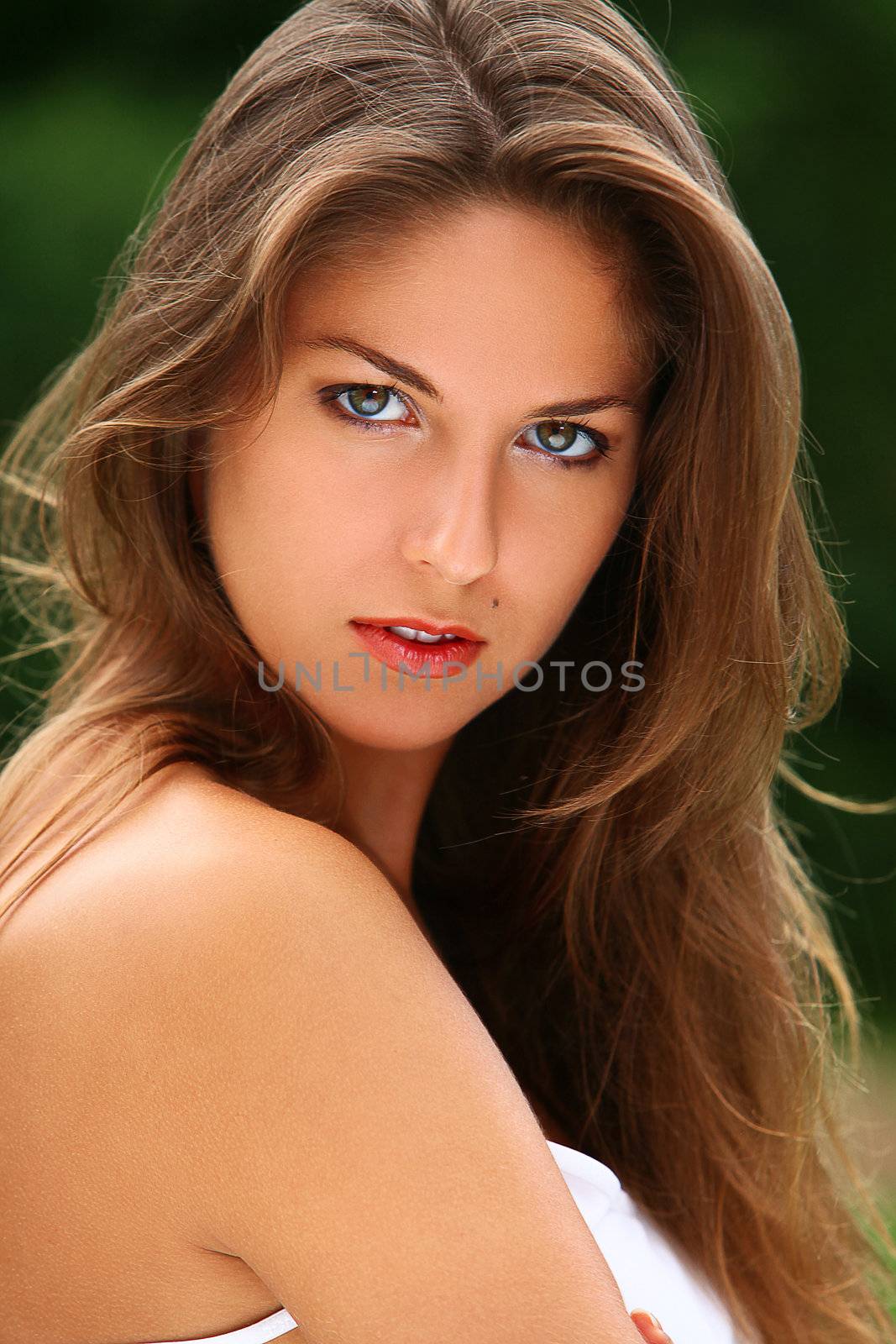 Portrait of young beautiful caucasian woman enjoy summer in a park