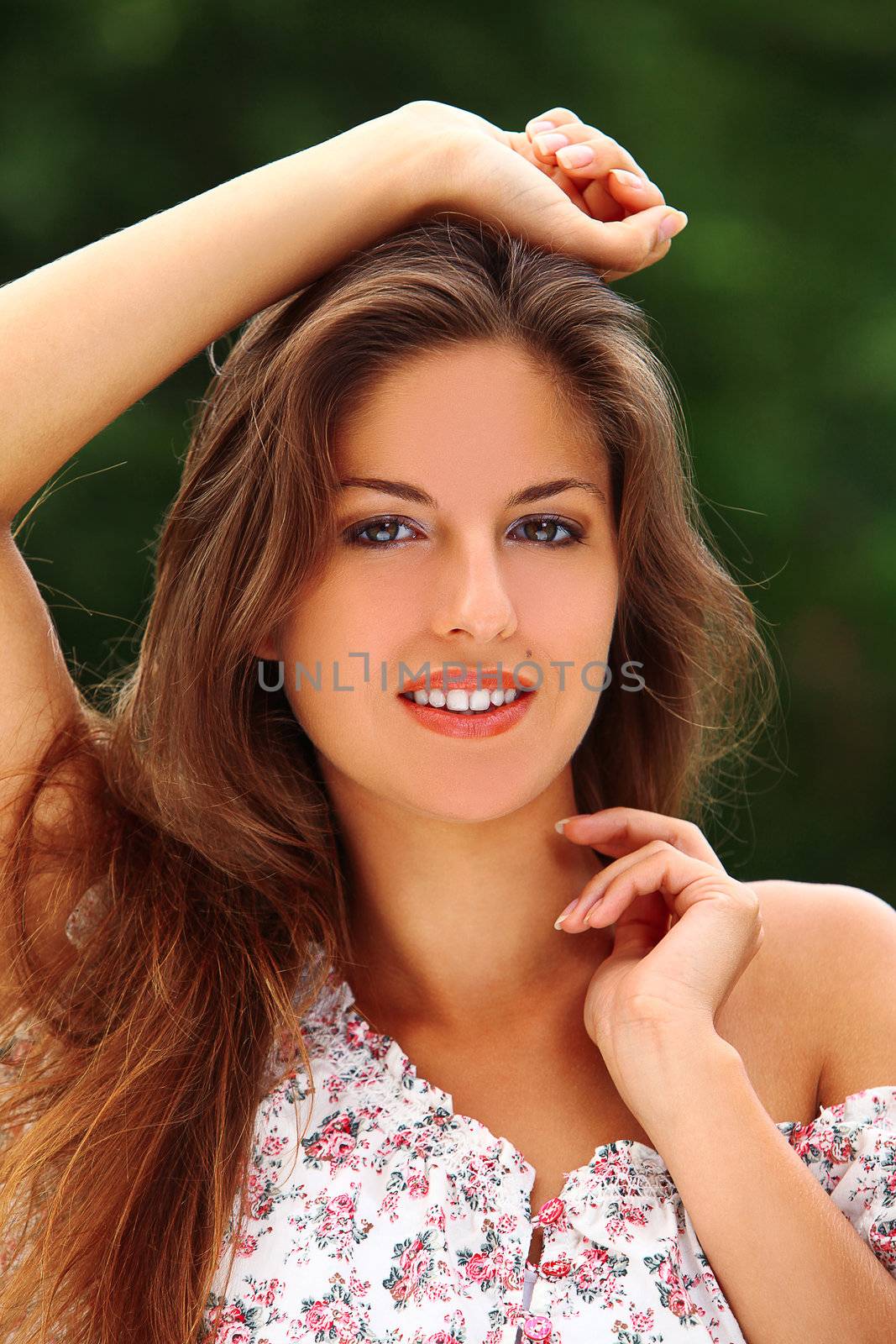 Portrait of young beautiful caucasian woman enjoy summer in a park