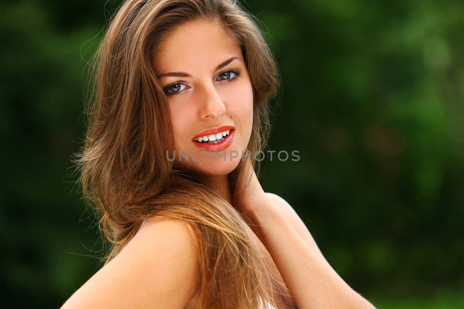 Portrait of young beautiful caucasian woman enjoy summer in a park