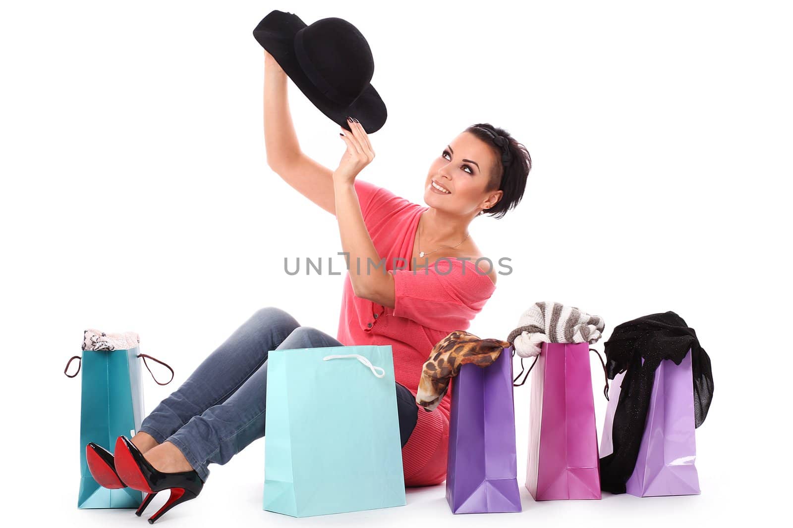 Young happy woman enjoys shopping isolated over white background