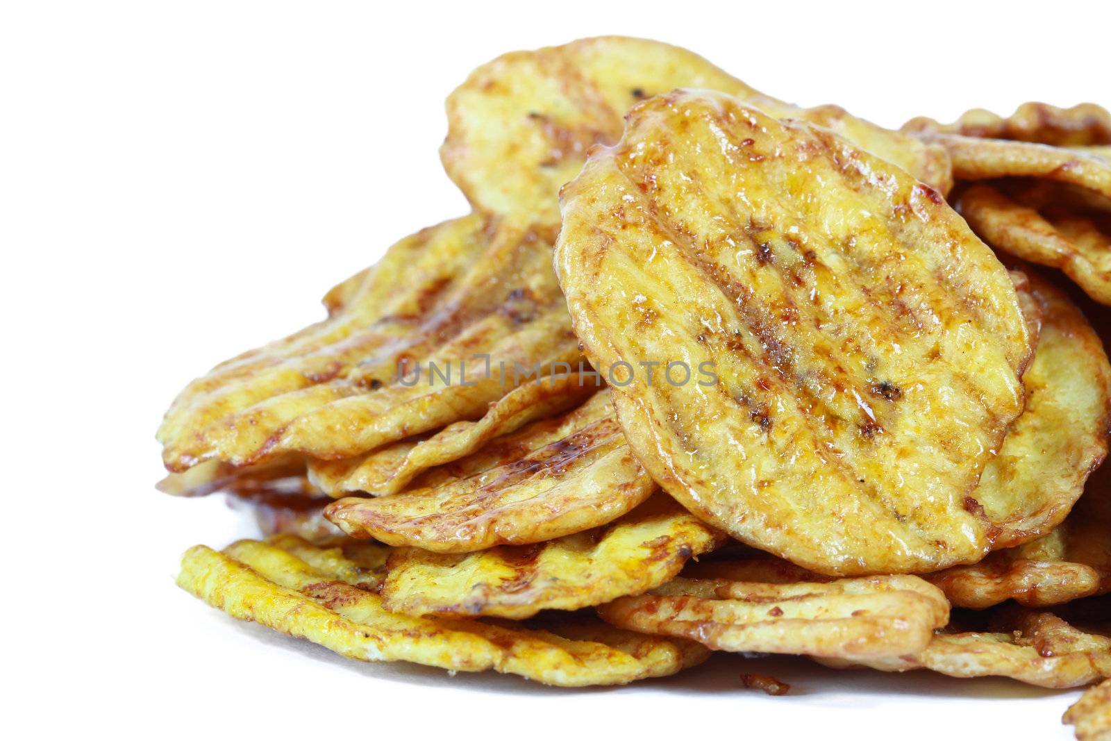 Fried thinly sliced banana chips, a tropical snack by bajita111122