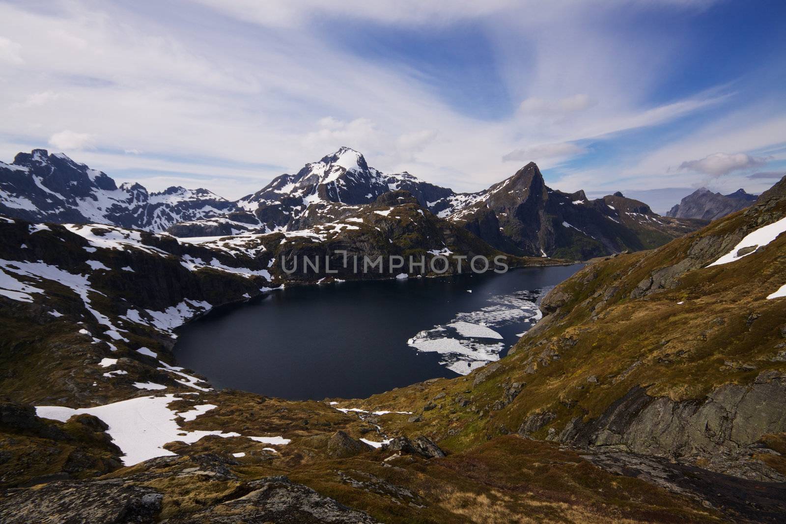 Scenic panorama with frozen fjord and mountain peaks in Norway