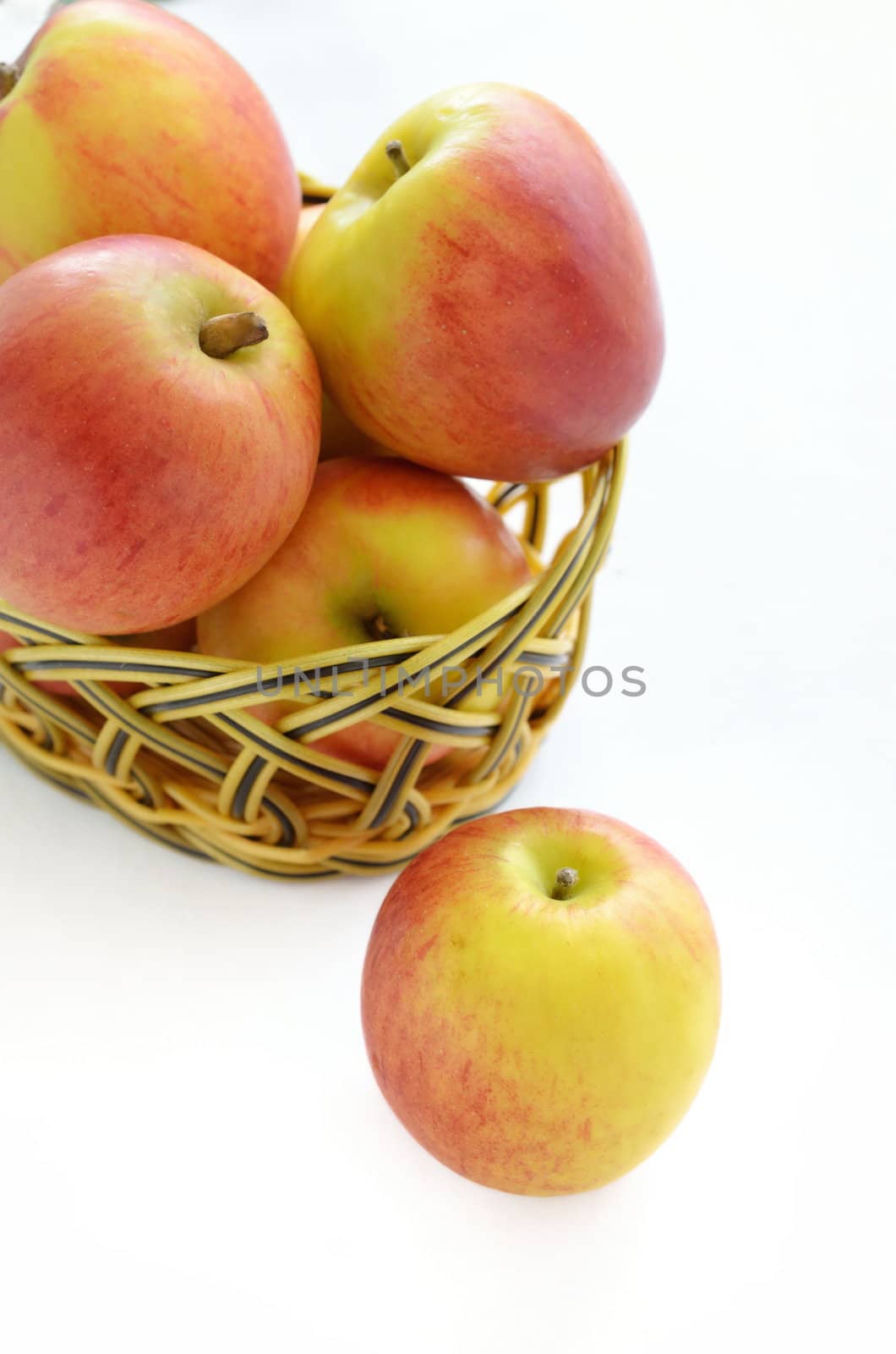 Apples in basket isolated on a white background