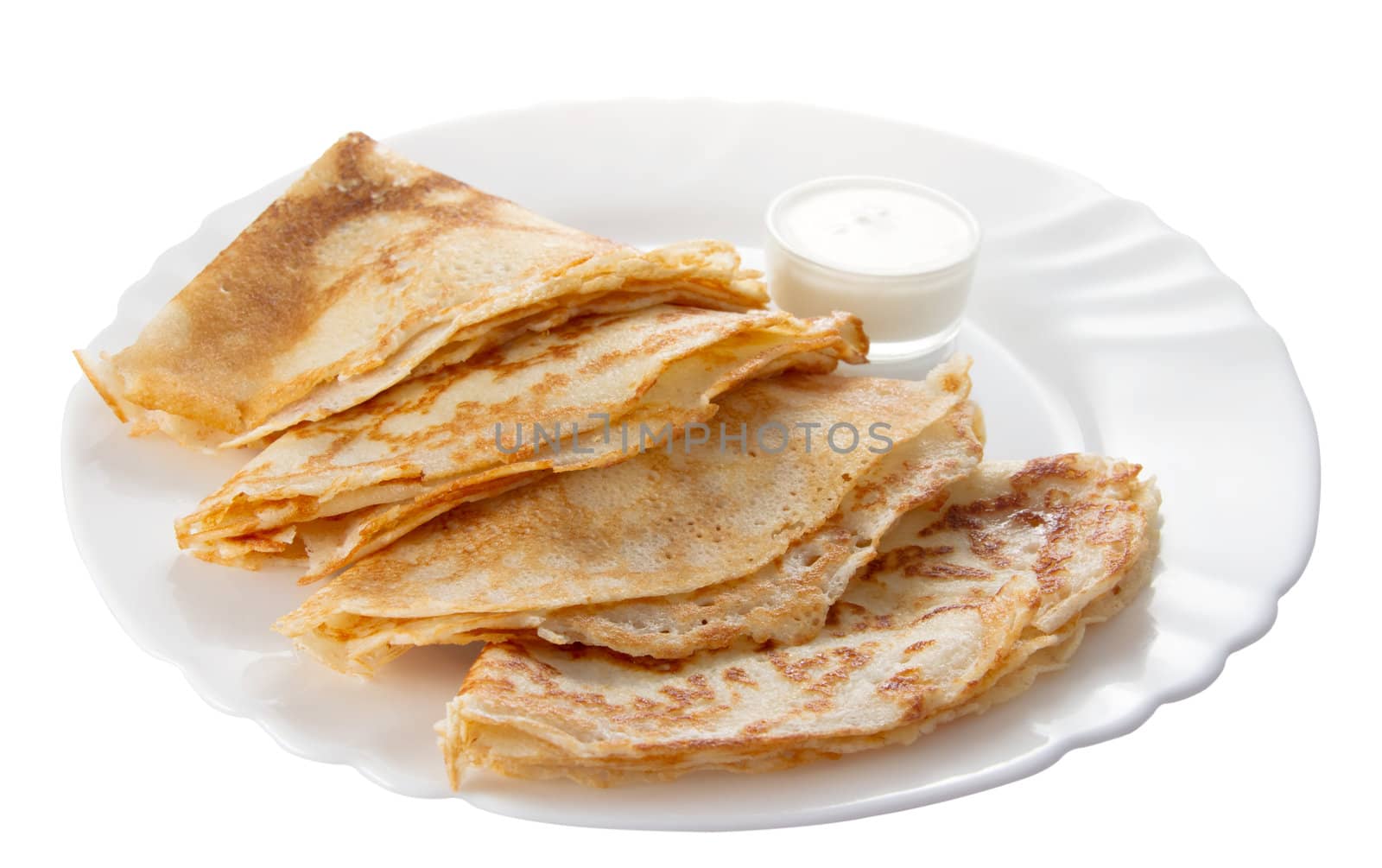 four pancakes with sour cream on a white plate (isolated object)