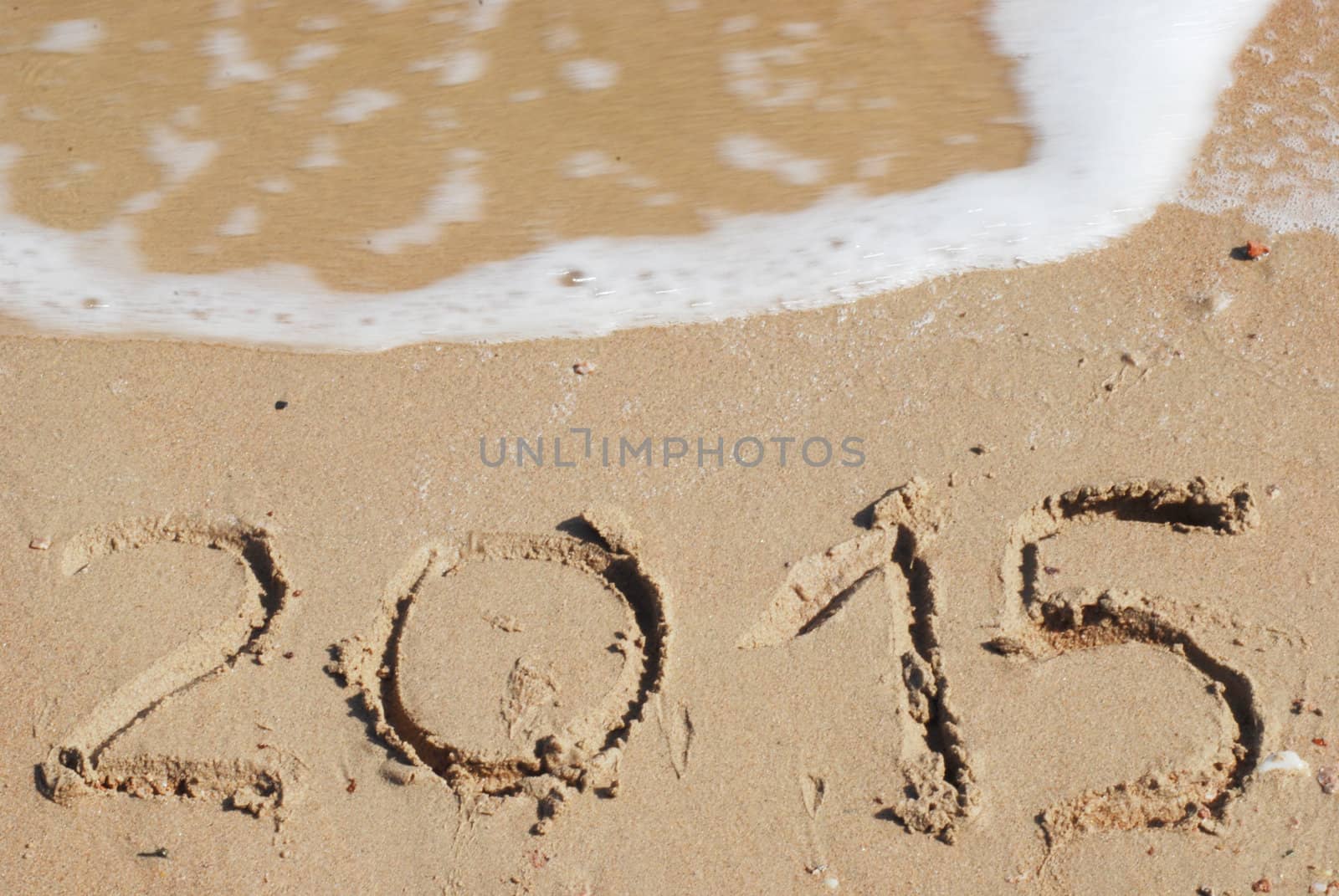 sand number 2015 on beach with wave