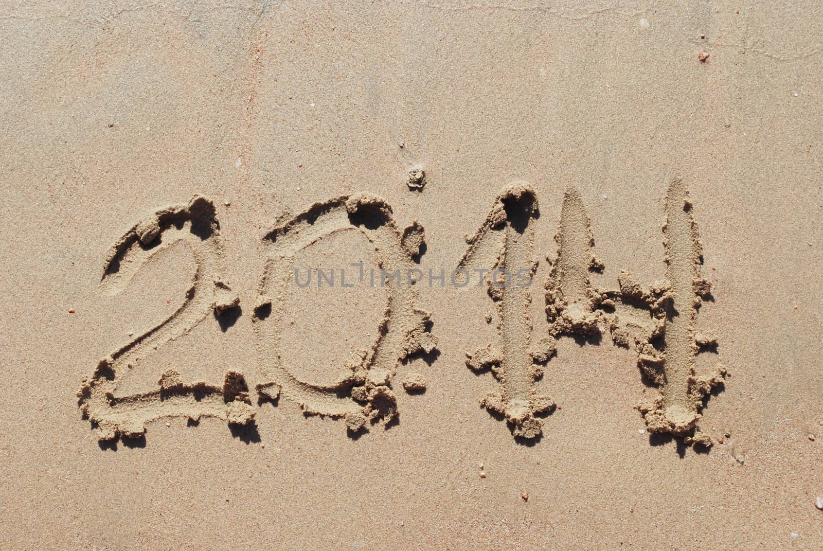 drawn sand number 2014 on beach of sea