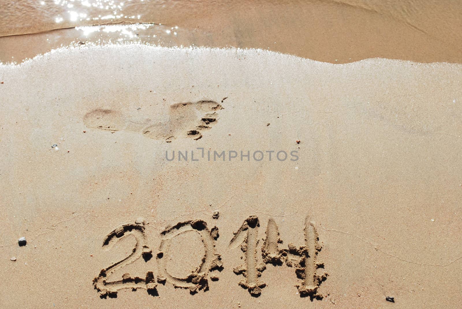 sand number 2014 on beach with wave and footprint 