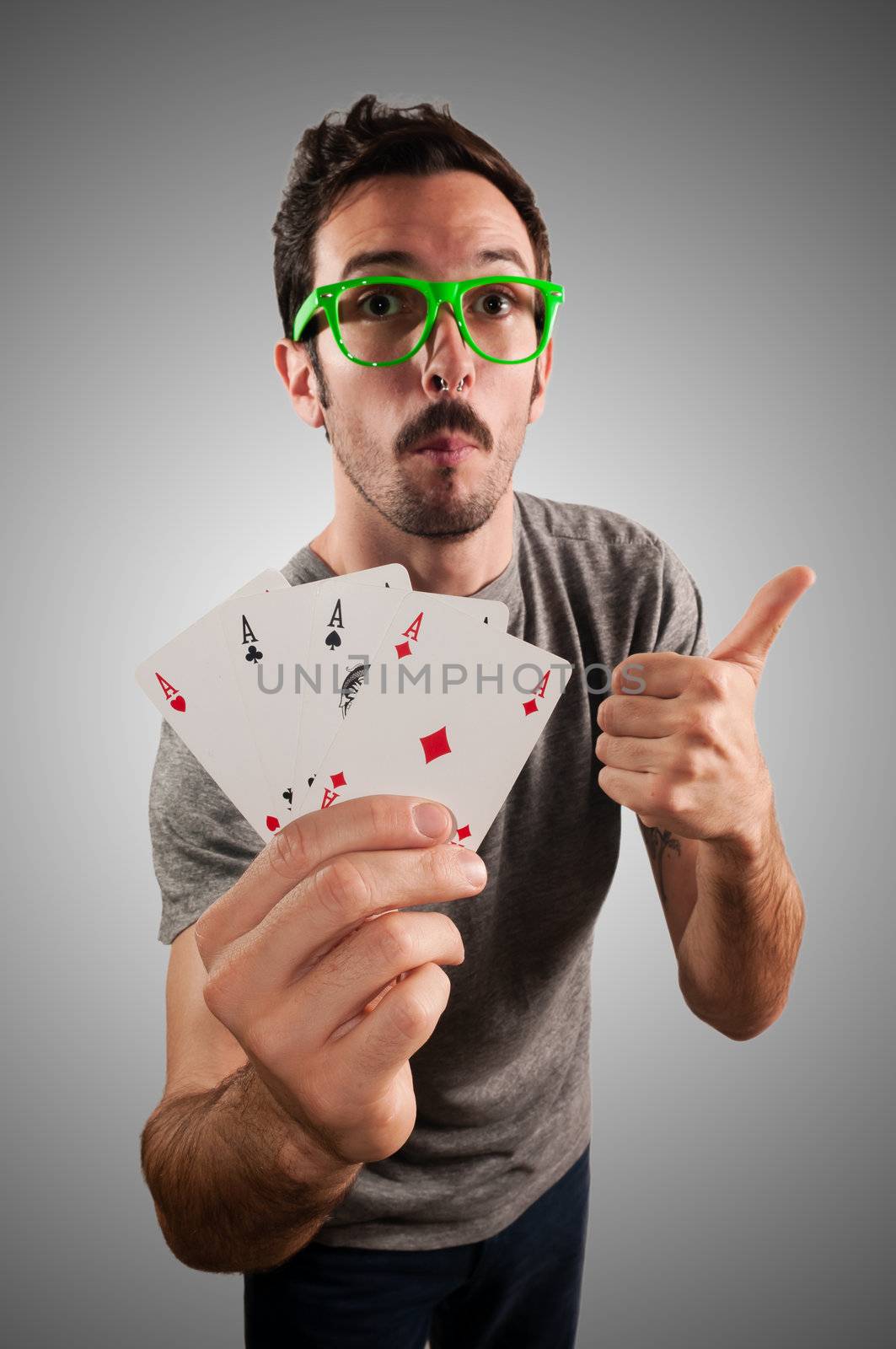 winner guy holding poker cards on grey background