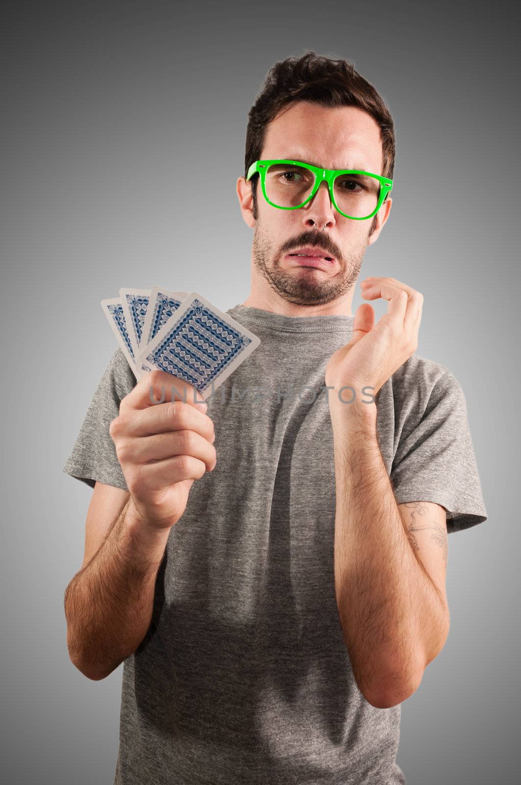 guy holding poker cards by peus