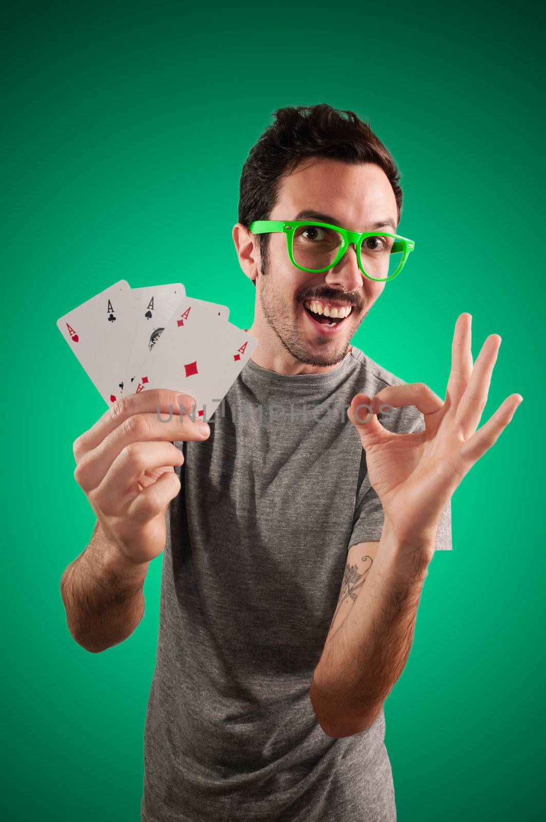 winner guy holding poker cards by peus