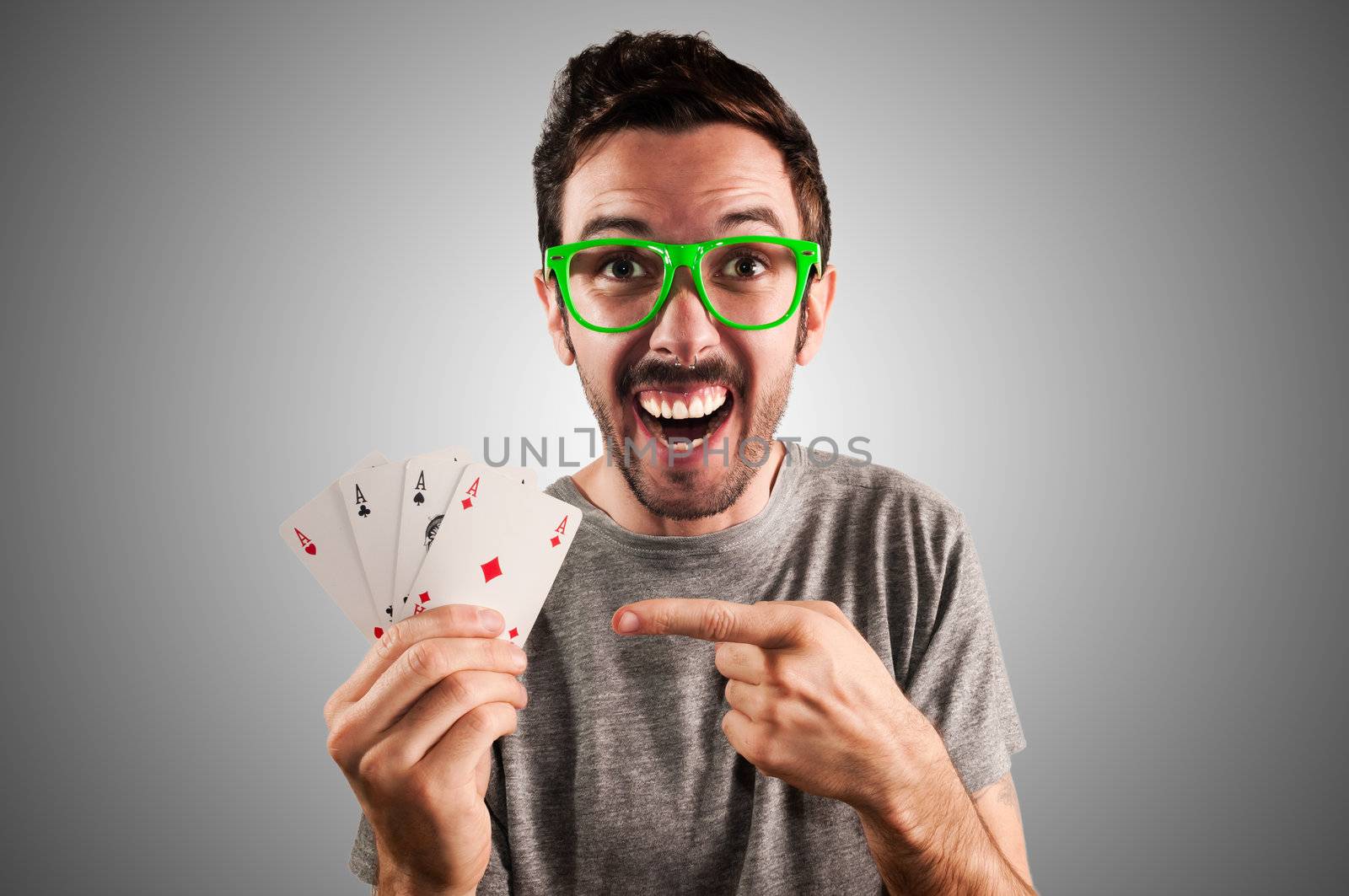 winner guy holding poker cards on grey background