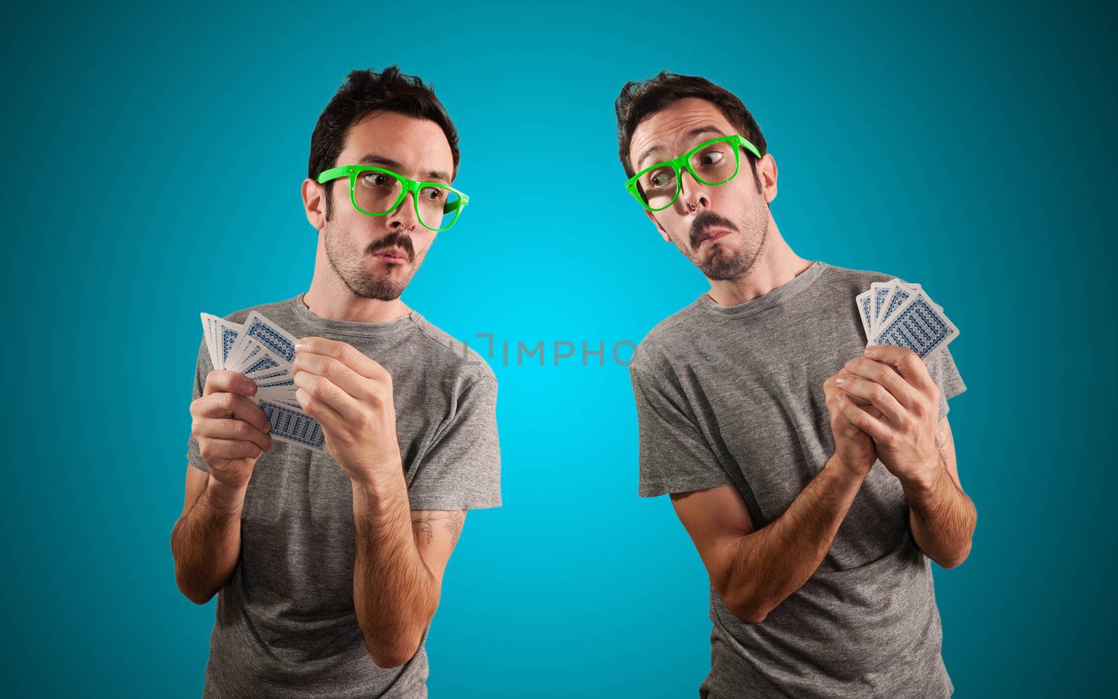 two guys spying poker cards on blue background