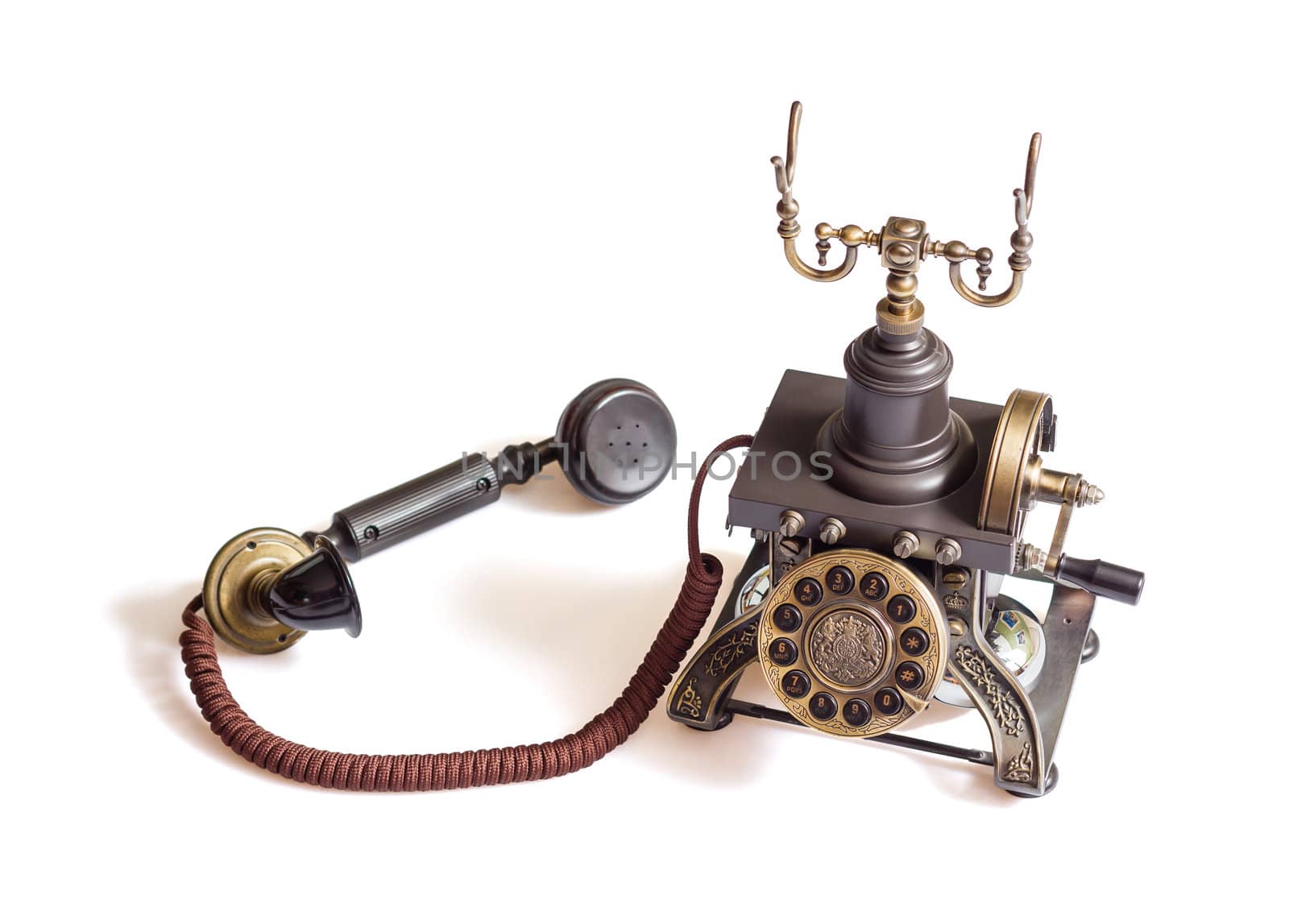 Decorated retro vintage metal telephone isolated on white background