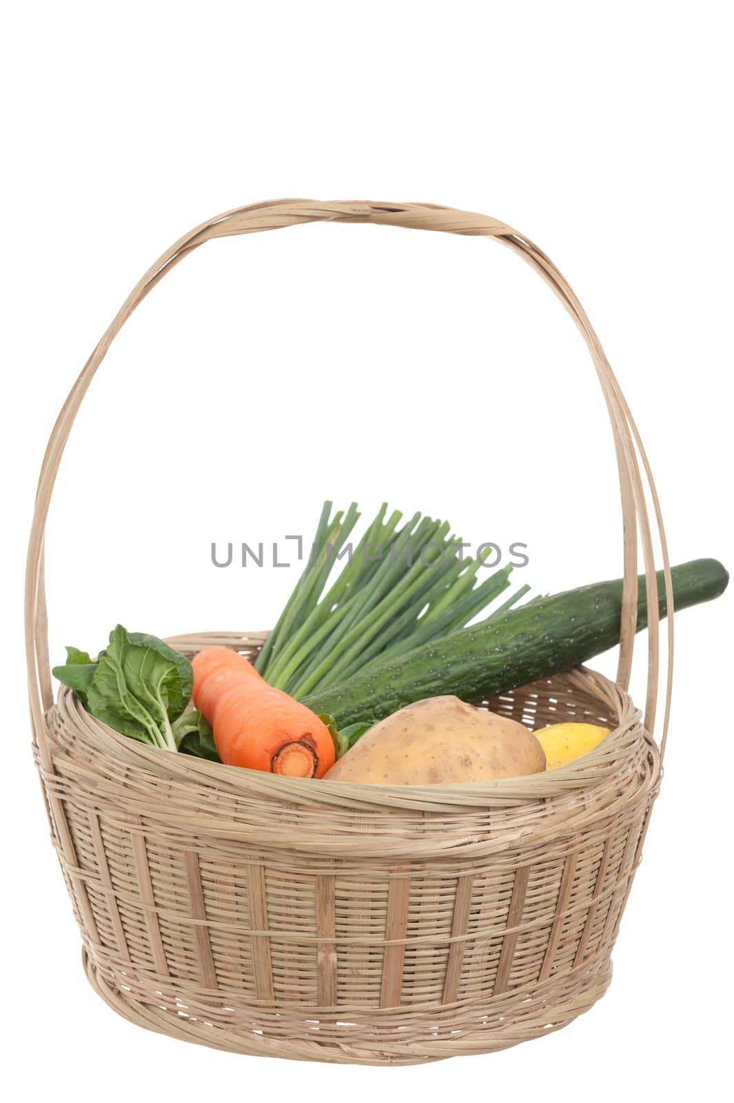 Vegetables in basket isolated on white background