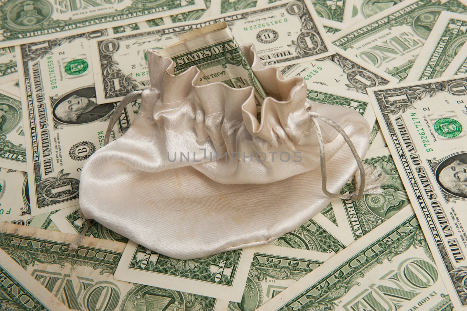 Money bag on paper money dollar pile