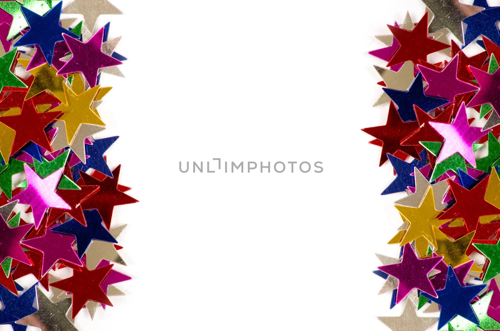 Christmas decoration of colored confetti stars against white background