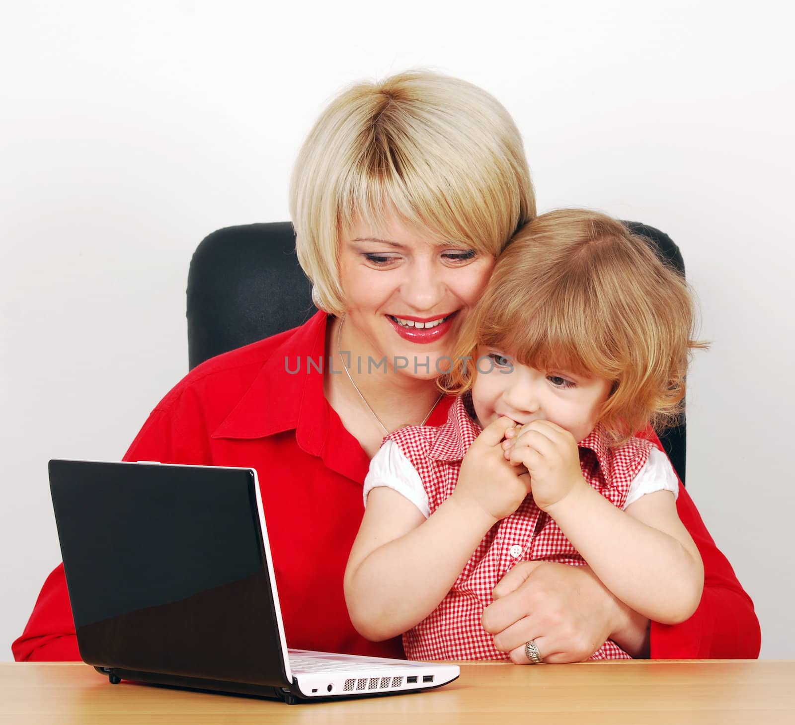 Daughter and mother with laptop studio shot by goce