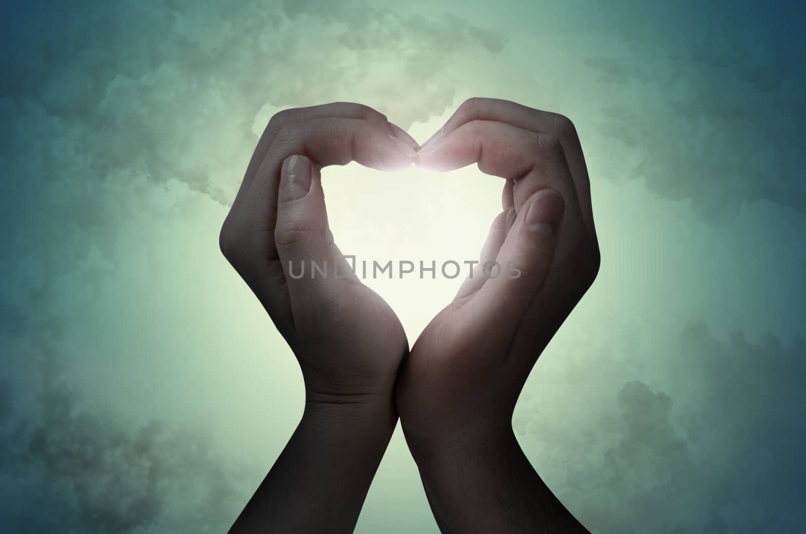 love shape hand silhouette in sky