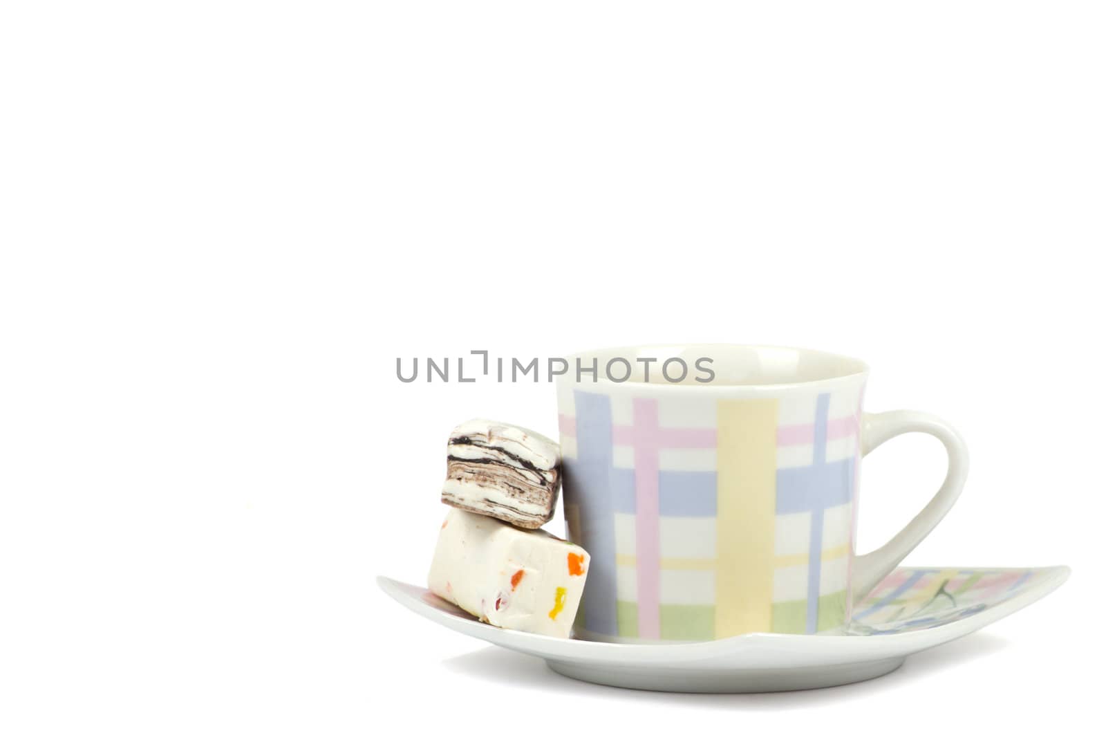 Coffee cup with sweets on white background
