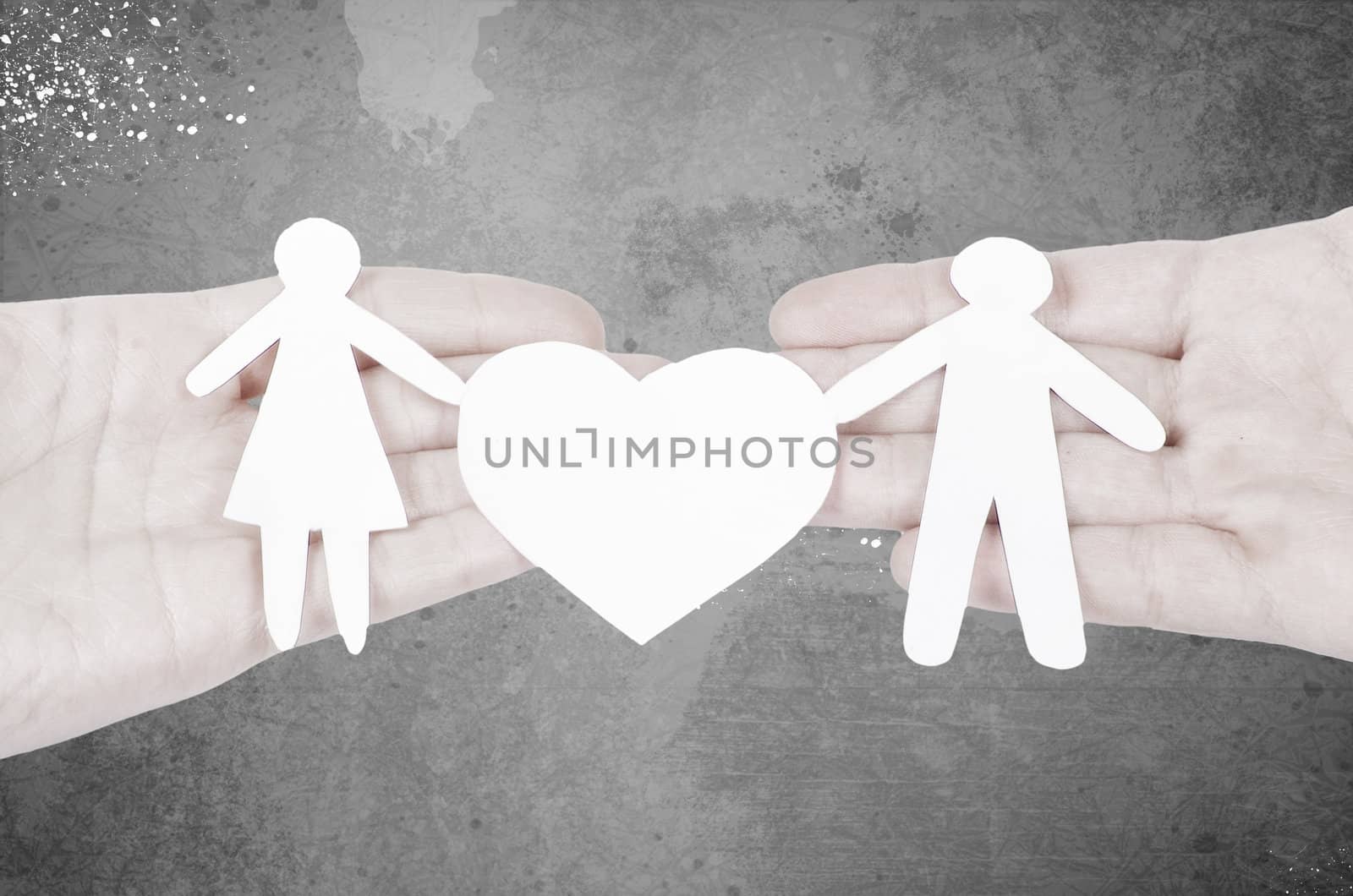Paper family in hand with a big hearth isolated on white