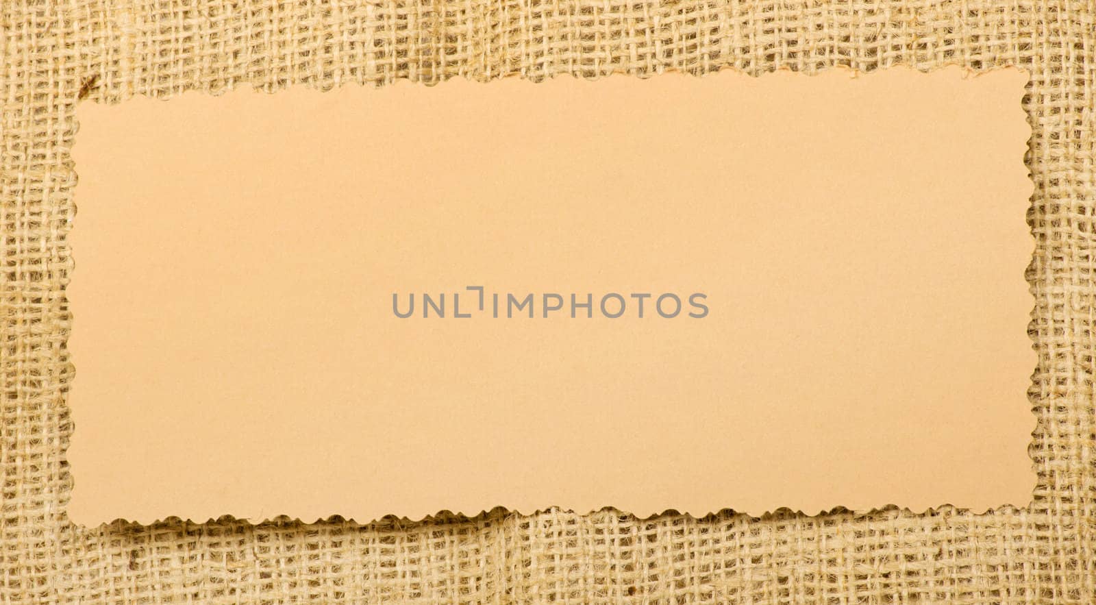 Old paper tag on natural burlap