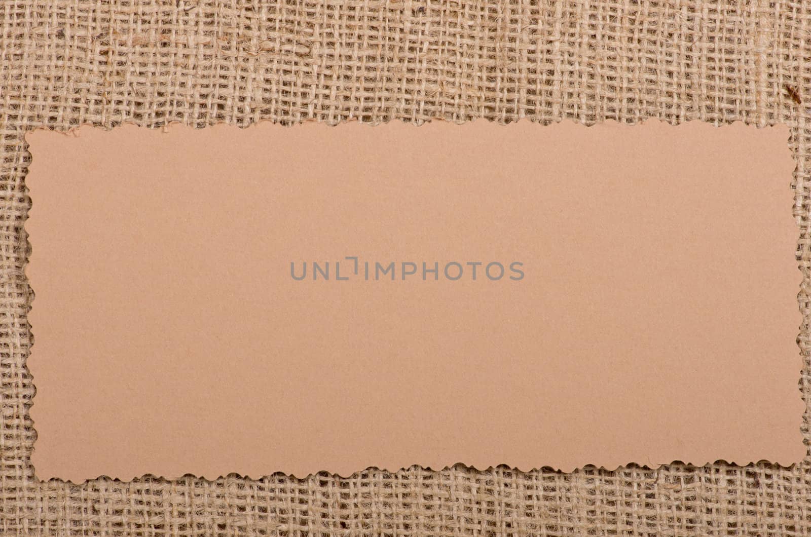 Old paper tag on natural burlap