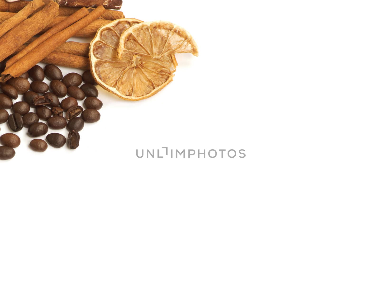 Coffee beans, cinnamon, lemon and sweets over white with a space for Your text