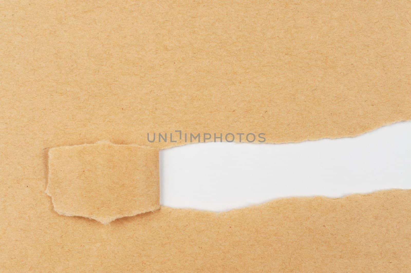 Torn yellow paper revealing white paper behind it